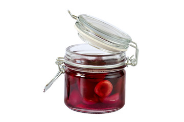Jam from sweet cherries in a glass jar with a lid. Isolated on white background