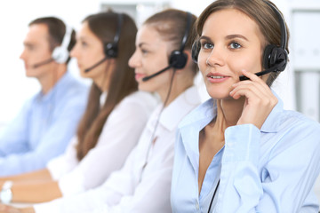 Call center operator in headset while consulting client. Telemarketing or phone sales. Customer service and business concept