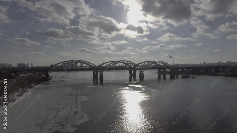Poster aerial view on the city with river in cloudy weather. modern bridge in spring season. on the coat un