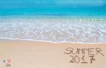 welcome to summer 2017 written on a tropical beach