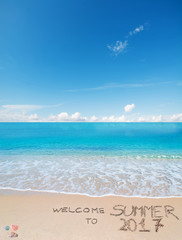 welcome to summer 2017 written on a tropical beach