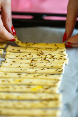 Woman hands put dough in the pan to be cooked