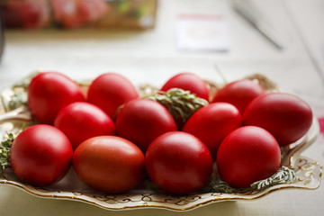 Bowl with red eggs on a table