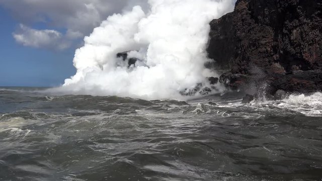 View of lava flowing into the ocean from the Hawaiian Boat Tour. Kilauea Volcano, Hawaii Big Island