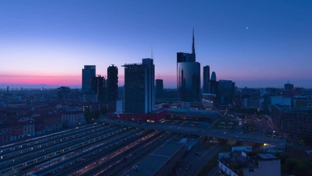 milan city timelapse sun rising over financial district