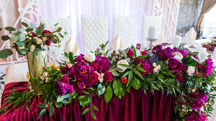 Wedding table decoration with pink flowers. Flower composition on a wedding table