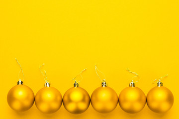 Christmas tree decoration balls on yellow background with copy space