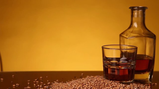 Whiskey or bourbon or skotch and corn on the table. camera movement from left to right