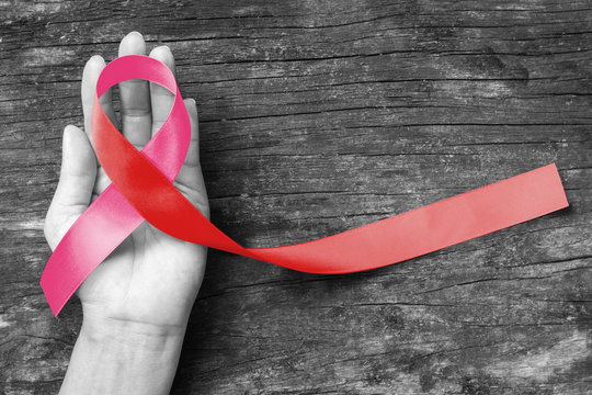 Pink ribbon - Red ribbon (isolated with clipping path) on symbolic color bow for HIV AIDS and breast, cervical cancer disease awareness