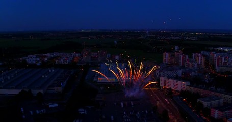 Fireworks over cityscape, taken from aerial perspective. Celebration and success.