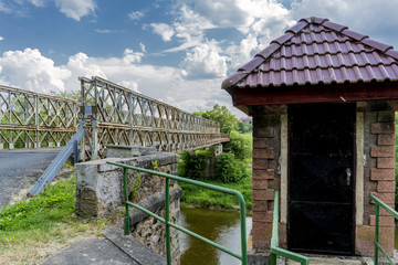 Fototapeta premium Old metal military bridge on the entrance road to the village of Kacov, Czech Republic