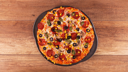 Pizza ready to eat - freshly baked, top view of baking pan