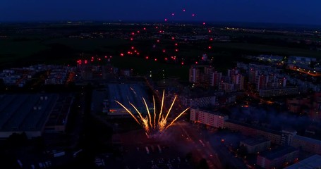 Fireworks over cityscape, taken from aerial perspective. Celebration and success.