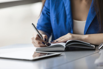 Close up of businesswoman with planner and pen