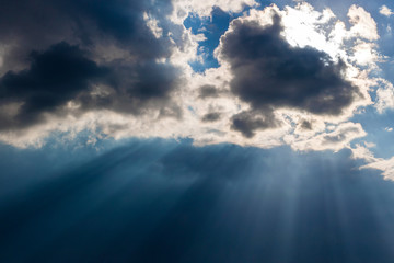 Heavy leaden sky with breaking sun rays