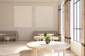 Cafe with round tables, posters