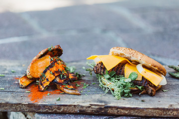 Cheeseburger with fresh meat from grill and sweet potatoe fries
