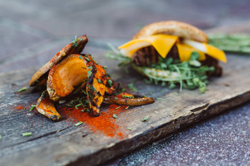 Cheeseburger with fresh meat from grill and sweet potatoe fries