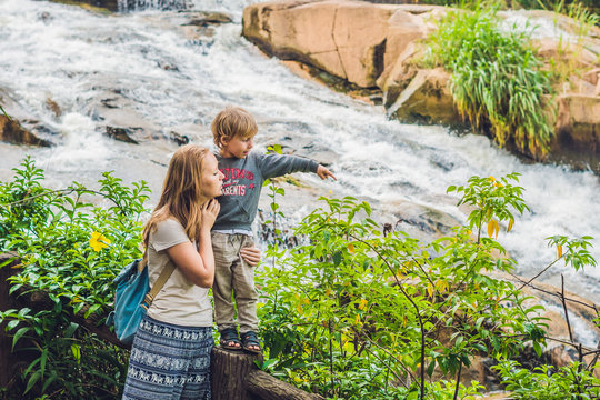 Mother and son on the background of Beautiful Camly waterfall In Da Lat city