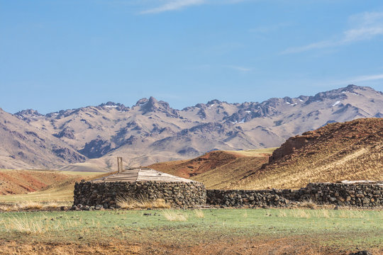 Panoramic view of house on plain with hills and mountains on background 