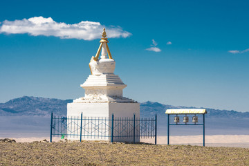 ancient traditional white stupa surrounded by metal fence at sunny day
