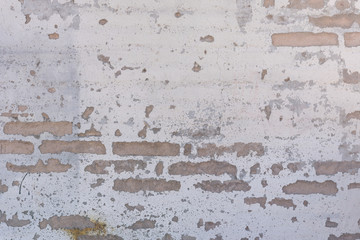 Worn Stucco and Brick Wall