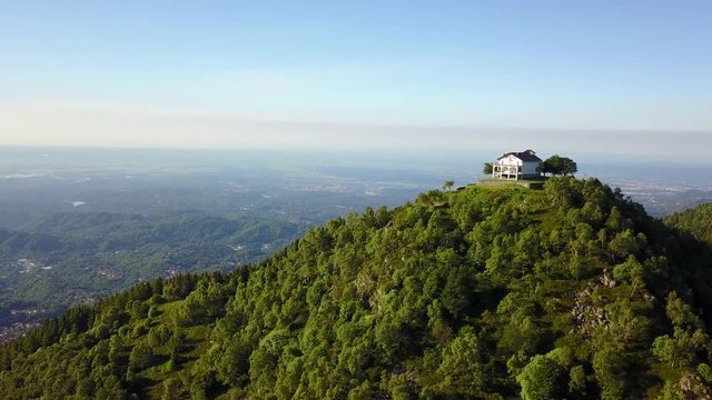 4K aerial view of a italian mountain church. Italian Alps, Trivero, Piemonte, Italy.
