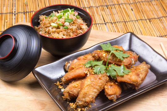 Fried chicken wings served with fry rice