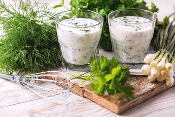 Ayran with fresh herbs. Traditional Turkish yoghurt drink.