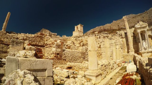 Antique Ruins Columns Heroon on Background Mountains Blue Sky