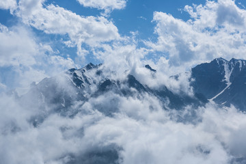 Fototapeta na wymiar Low clouds on the mountain peaks, Kazakhstan, Kyrgyzstan