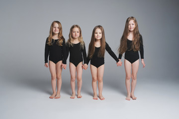 four young beautiful models on grey