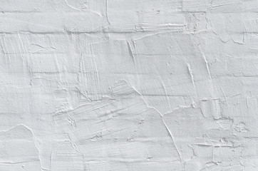 Thin layer of plaster on a brick wall. White and gray plaster wall texture. Empty background