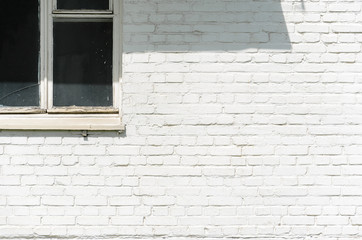 A white brick wall facade with window