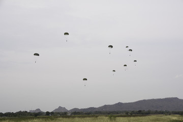 Many soldiers parachute. Going down to the ground