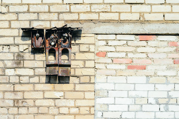 Abandoned building. Destroyed old alarm system on the old brick facade. Old brick wall texture