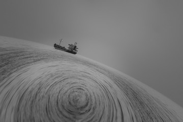 Abstract image of the cargo ship in motion on the background of the sea in black and white