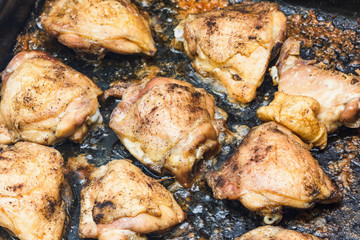 Chicken frying in a pan.