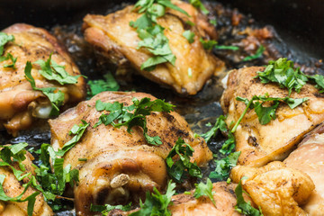 Chicken frying in a pan.