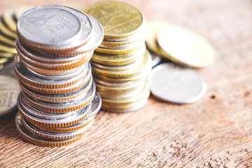 Row of coins on wood background for finance and Saving concept,Investment, Economy, Soft focus and dark style.