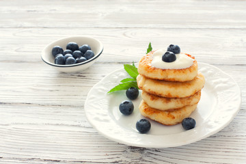 Delicious cottage cheese pancakes or syrniki with fresh blueberry
