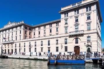Venice, Veneto / Italy- May 20, 2017: Buildings and people walking on the bank of the Grand Canal in Venice