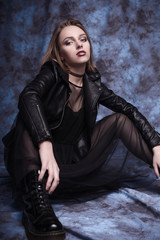 Naklejka premium High fashion look, glamor stylish beautiful young woman model with red lips in hipster rock black cloth in boots. Retouched shot