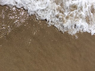 Foaming wave at the beach