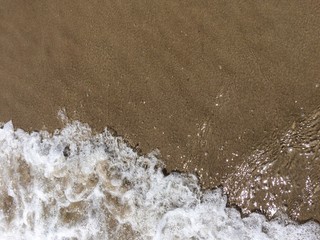 Foaming wave at the beach