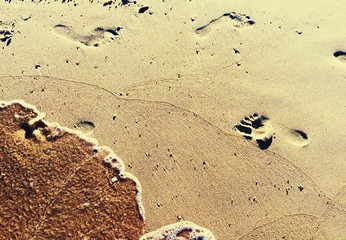 Footprints on a sand  at the seashore