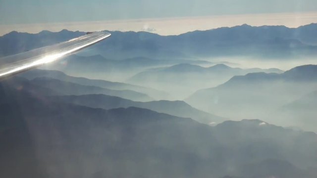 Mountains of Taiwan with clouds, aerial view from an airplane. The geography of Taiwan isn't plain. About 70% of the island is covered with rugged, densely forested mountains.