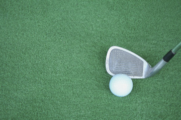 Golf clubs and golf balls on green artificial grass At the golf driving range