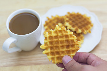 Coffee and butter wafer on wooden