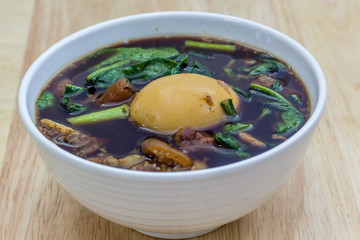 Braised pork or Boiled pork leg Thai food on wooden